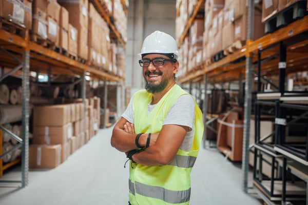Cheerful Warehouse Worker with Box Background